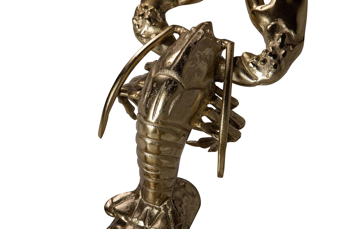 A metallic lobster figurine with a textured, antique gold finish, shown in a close-up detail shot.