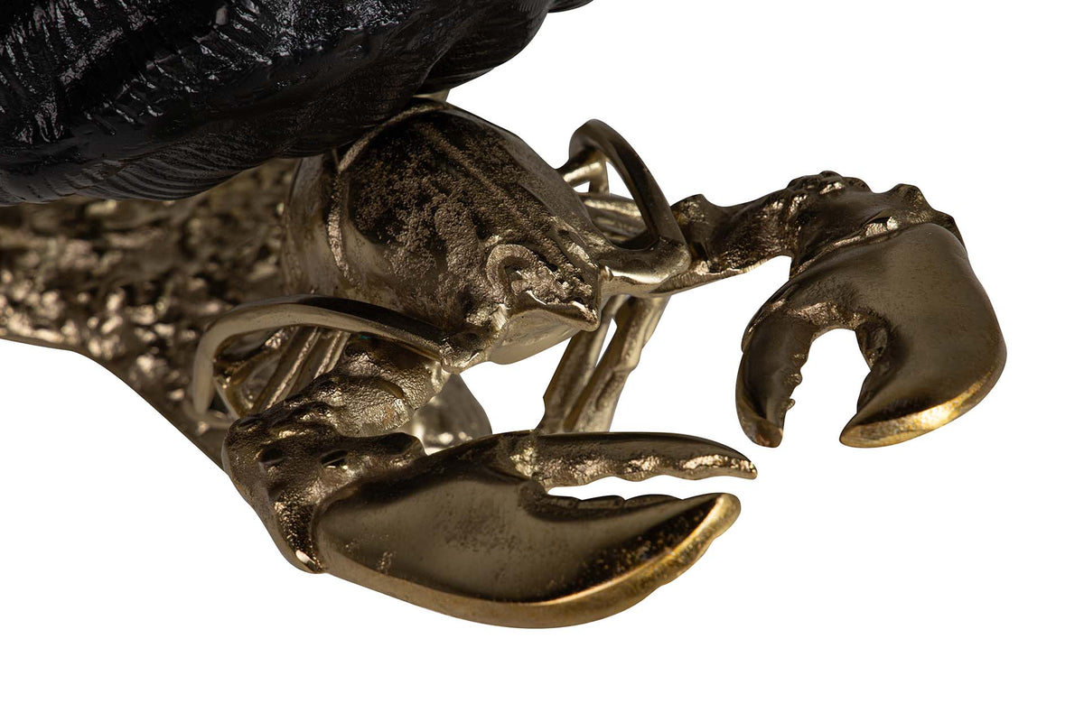 Close-up detail of a lobster chapagne cooler with metallic gold-toned claws and body.