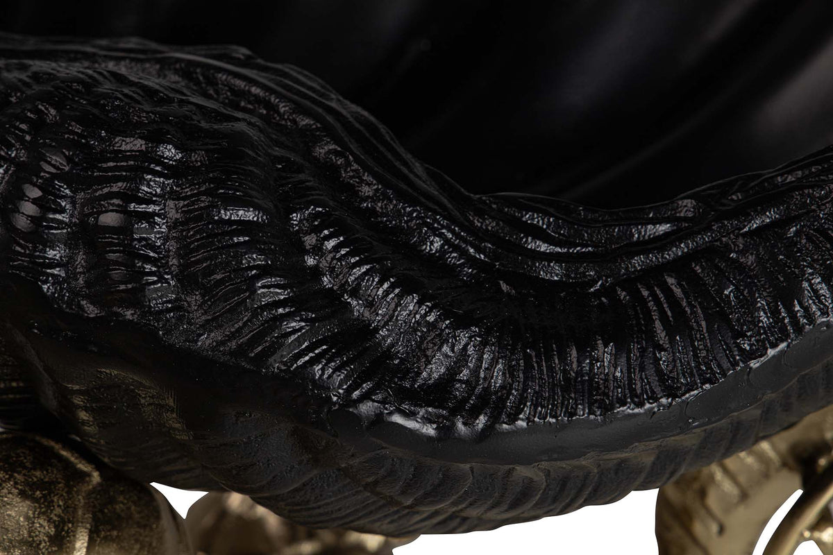 Close-up detail of a glossy black aluminium bowl for champagne cooler. Object with ribbed ridges and a smooth curved surface.