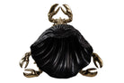 A decorative crab figurine with metallic gold claws and legs surrounding a large black shell-shaped body, shown on a plain white background.