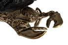 Close-up detail of a lobster chapagne cooler with metallic gold-toned claws and body.