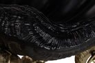 Close-up detail of a glossy black aluminium bowl for champagne cooler. Object with ribbed ridges and a smooth curved surface.