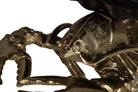 Close-up detail of a metallic lobster sculpture of champagne cooler with a textured, antique gold finish.